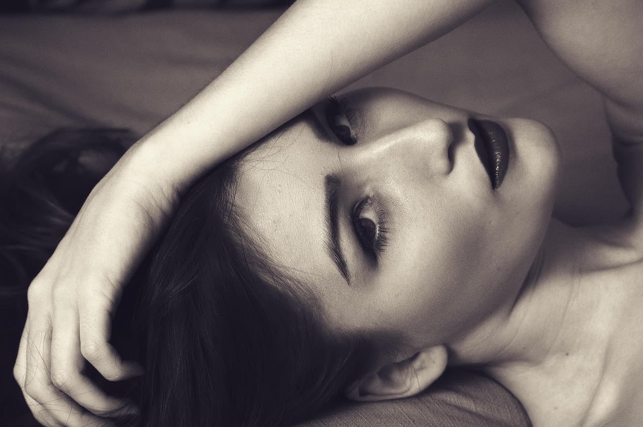 Black and white portrait of a woman with softly arched brows
